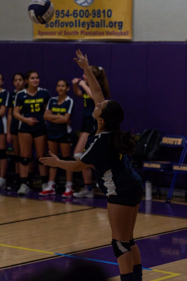 8th grader Ana Mayo serves the volleyball to start the match on last years volleyball team.